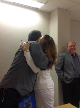 Gladys recibe un caluroso abrazo de su esposo al concluir la defensa y deliberación.  Observa con mucha alegría el Dr. Walter Silva. / Foto por: Grisobelle Virella